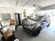 Spacious garage featuring car parking, laundry area and white brick walls at 13924 Pathfinder Dr, Tampa, FL 33625