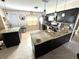 Updated kitchen showcasing an island, dark cabinets, granite countertops, and stainless steel appliances at 13924 Pathfinder Dr, Tampa, FL 33625