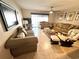 Inviting living room with comfortable seating, neutral colors, tile flooring, and access to the outdoor space at 13924 Pathfinder Dr, Tampa, FL 33625