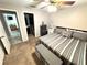 Bedroom with carpet, ceiling fan, and an en-suite bathroom, offering comfort and convenience at 13924 Pathfinder Dr, Tampa, FL 33625