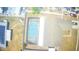 Aerial view of screened-in pool, aging roof, surrounding yard, and some trees in the background at 13924 Pathfinder Dr, Tampa, FL 33625