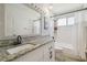Bright bathroom features white vanity with granite top, updated fixtures, tile shower and tub at 1517 Little Brook Ln, Brandon, FL 33511