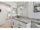 Bright bathroom with granite countertops, white cabinets, and decorative mirror at 1517 Little Brook Ln, Brandon, FL 33511