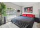 This cozy bedroom features an arched window, soft rug, and modern decor at 1517 Little Brook Ln, Brandon, FL 33511