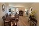 Formal dining room features a large wood table, comfortable seating, and views into the kitchen and living spaces at 1517 Little Brook Ln, Brandon, FL 33511