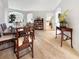 Spacious dining area with elegant table set, decorative furnishings, and wood-look tile flowing seamlessly into the kitchen at 1517 Little Brook Ln, Brandon, FL 33511