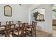 Elegant dining area with wood-look tile flooring, seating for eight, and arched display nook at 1517 Little Brook Ln, Brandon, FL 33511