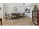 Elegant dining room featuring wood-look tile flooring, a formal dining table, and ample space for entertaining at 1517 Little Brook Ln, Brandon, FL 33511