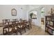 Charming dining area featuring wood-look tile, seating for eight, and a glimpse into the living room at 1517 Little Brook Ln, Brandon, FL 33511