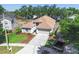 Aerial view of a well-maintained home with a new roof, landscaped yard, and a long driveway at 1517 Little Brook Ln, Brandon, FL 33511