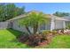 Beautiful home showcasing manicured landscaping and palm trees, adding curb appeal at 1517 Little Brook Ln, Brandon, FL 33511
