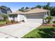 Charming home with a well-maintained yard, gray garage door, and a concrete driveway at 1517 Little Brook Ln, Brandon, FL 33511
