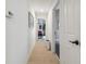 Bright hallway with tile flooring and doors leading to various rooms in the home at 1517 Little Brook Ln, Brandon, FL 33511