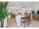 Bright kitchen with white cabinets, stainless appliances and island with seating for two at 1517 Little Brook Ln, Brandon, FL 33511
