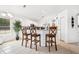 Bright kitchen featuring white cabinets, modern appliances, and a counter with bar stools, perfect for casual dining at 1517 Little Brook Ln, Brandon, FL 33511