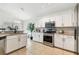 Well-appointed kitchen featuring white cabinets, stainless steel appliances, and tiled flooring at 1517 Little Brook Ln, Brandon, FL 33511