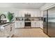 Well-lit kitchen featuring tiled flooring, stainless steel appliances, and granite countertops at 1517 Little Brook Ln, Brandon, FL 33511