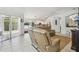 Open-concept living room and kitchen with neutral colors, tile floors, and lots of natural light at 1517 Little Brook Ln, Brandon, FL 33511