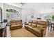 Spacious living room with vaulted ceilings, large windows, and comfortable leather seating at 1517 Little Brook Ln, Brandon, FL 33511