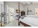 View of main bedroom with a four poster bed, entertainment center, and open doorway to other rooms at 1517 Little Brook Ln, Brandon, FL 33511