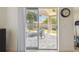 View from interior to a stone patio and private backyard, with neutral colors and natural light at 1517 Little Brook Ln, Brandon, FL 33511
