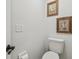 Neutral powder room with framed wall art and natural light at 1517 Little Brook Ln, Brandon, FL 33511