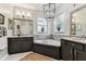 Relaxing bathroom with a soaking tub, marble backsplash, and contemporary lighting at 1816 Curry Rd, Lutz, FL 33549