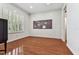 Empty bedroom with hardwood floors, plantation shutters, and a neutral color palette at 1816 Curry Rd, Lutz, FL 33549