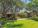 Charming single-story home featuring a lush, landscaped front yard and inviting curb appeal at 1816 Curry Rd, Lutz, FL 33549