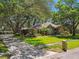 Beautiful single-story home with manicured lawn, mature trees, and a long driveway at 1816 Curry Rd, Lutz, FL 33549