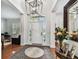 Bright foyer with tile flooring, statement lighting, and views into the formal living areas at 1816 Curry Rd, Lutz, FL 33549