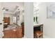 Open hallway featuring hardwood floors, leading to the bedroom and bathroom areas at 1816 Curry Rd, Lutz, FL 33549