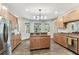 Spacious kitchen featuring wood cabinets, granite countertops, and a center island at 1816 Curry Rd, Lutz, FL 33549