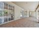 Covered patio with tiled floors featuring several windows and doors that offer natural light, and scenic views at 1816 Curry Rd, Lutz, FL 33549