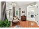 Bright sitting area with large windows, hardwood floors, and charming decor at 1816 Curry Rd, Lutz, FL 33549