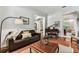 Cozy sitting room with hardwood floors, grand piano, and comfortable leather seating at 1816 Curry Rd, Lutz, FL 33549