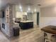 Modern kitchen with white cabinets, stainless steel appliances, an island, and stylish wood flooring at 1967 Bonnie Ct, Dunedin, FL 34698