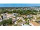 Wide aerial shot showcases the neighborhood, with lush trees, several lakes, and the home in the foreground at 221 Lakeway Ln, Apollo Beach, FL 33572