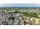 This aerial shot captures the home amidst a bustling community, highlighting the lush trees, nearby lakes, and the beautiful skyline at 221 Lakeway Ln, Apollo Beach, FL 33572