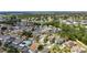A bird's-eye view showcasing the home's location within a well-established community with mature trees, and neighborhood ponds at 221 Lakeway Ln, Apollo Beach, FL 33572