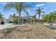 Beautiful backyard with a screened-in pool and lush tropical landscaping at 221 Lakeway Ln, Apollo Beach, FL 33572