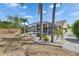Backyard view featuring a screened-in pool, tropical foliage and paved walkway at 221 Lakeway Ln, Apollo Beach, FL 33572