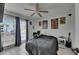 Comfortable bedroom with ceiling fan, natural light, and a desk area at 221 Lakeway Ln, Apollo Beach, FL 33572