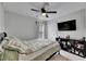 This bright bedroom features a ceiling fan, neutral walls, and tile flooring at 221 Lakeway Ln, Apollo Beach, FL 33572