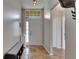 Inviting foyer features tile flooring, a bench with shoe storage, and a transom window above the front door at 221 Lakeway Ln, Apollo Beach, FL 33572