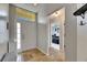 Welcoming foyer with tile flooring and transom window, leading to the bedrooms at 221 Lakeway Ln, Apollo Beach, FL 33572