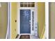 Stylish front door with sidelight, a welcome mat, and a decorative 