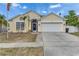 Charming single-story home with a two-car garage and well-maintained front yard at 221 Lakeway Ln, Apollo Beach, FL 33572