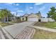 Residential house with front lawn, two-car garage, and traditional design elements at 221 Lakeway Ln, Apollo Beach, FL 33572