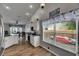 Open concept kitchen features stainless steel appliances and wood flooring at 221 Lakeway Ln, Apollo Beach, FL 33572